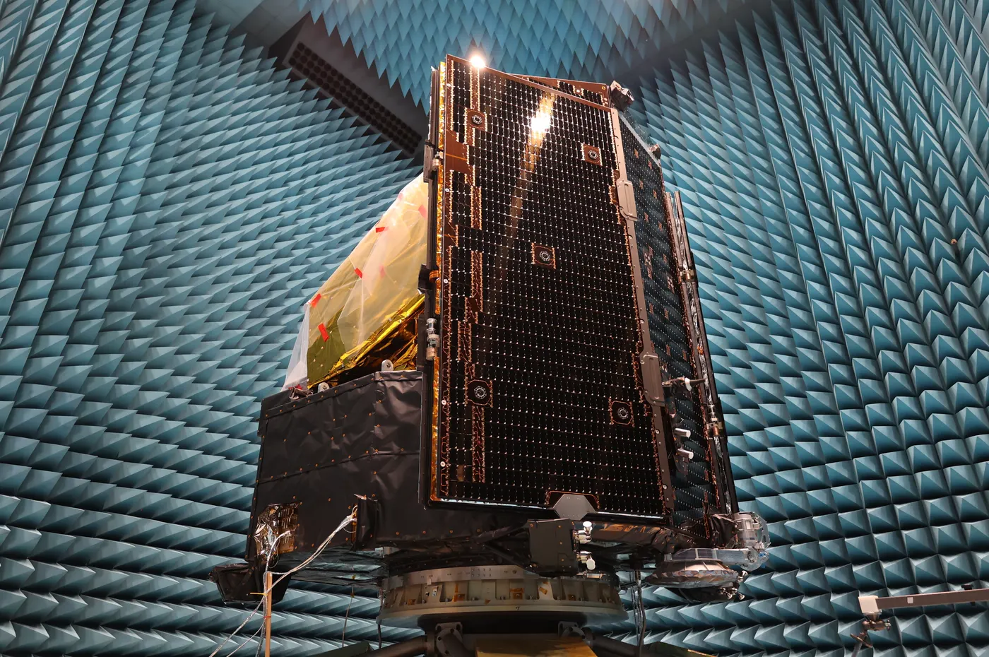 Spacecraft under electromagnetic compatibility test in an anechoic chamber
